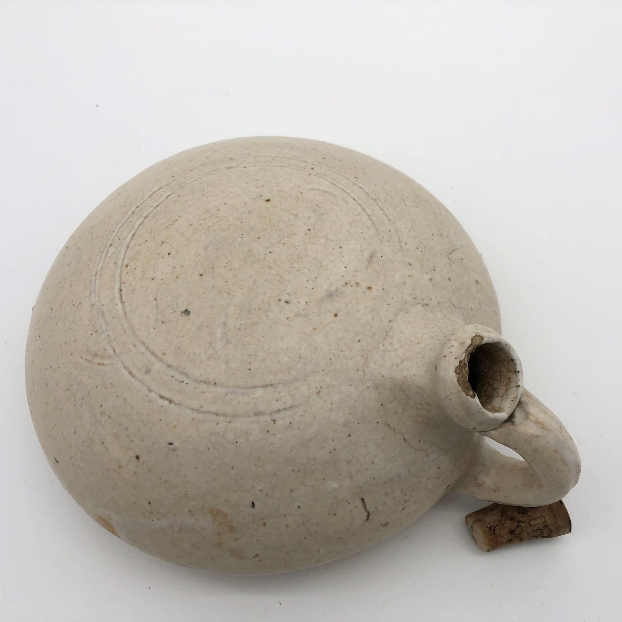 Old round sandstone hot water bottle