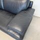 Two-seater Natuzzi sofa in navy blue leather.