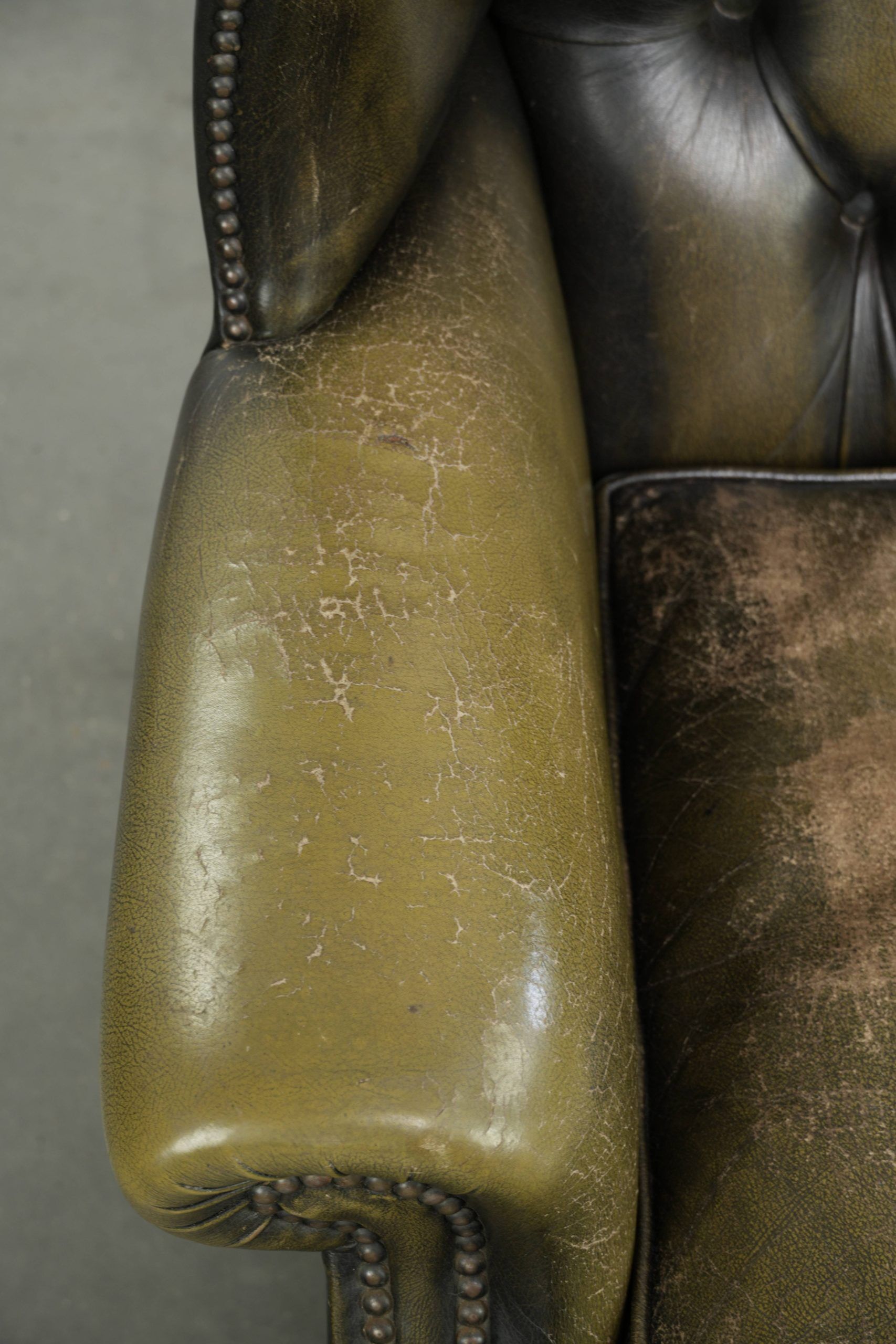 Vintage cowhide leather Chesterfield wingback armchair in a green colour