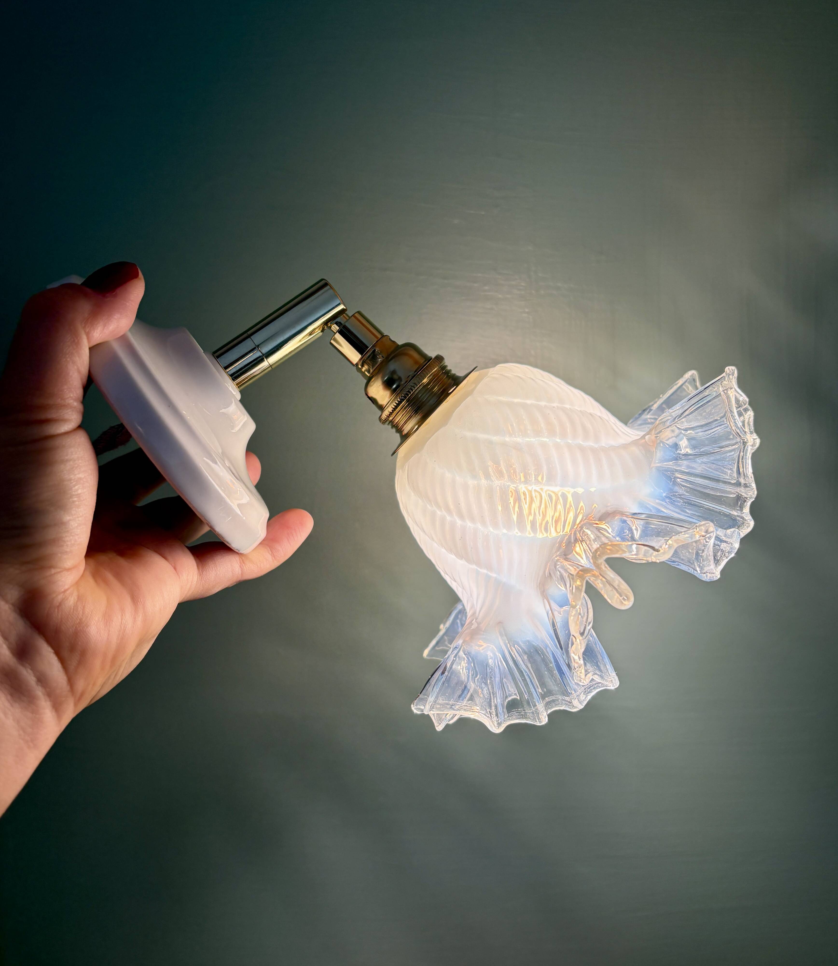 Vintage tulip glass wall light in transparent, slightly pearlescent white.