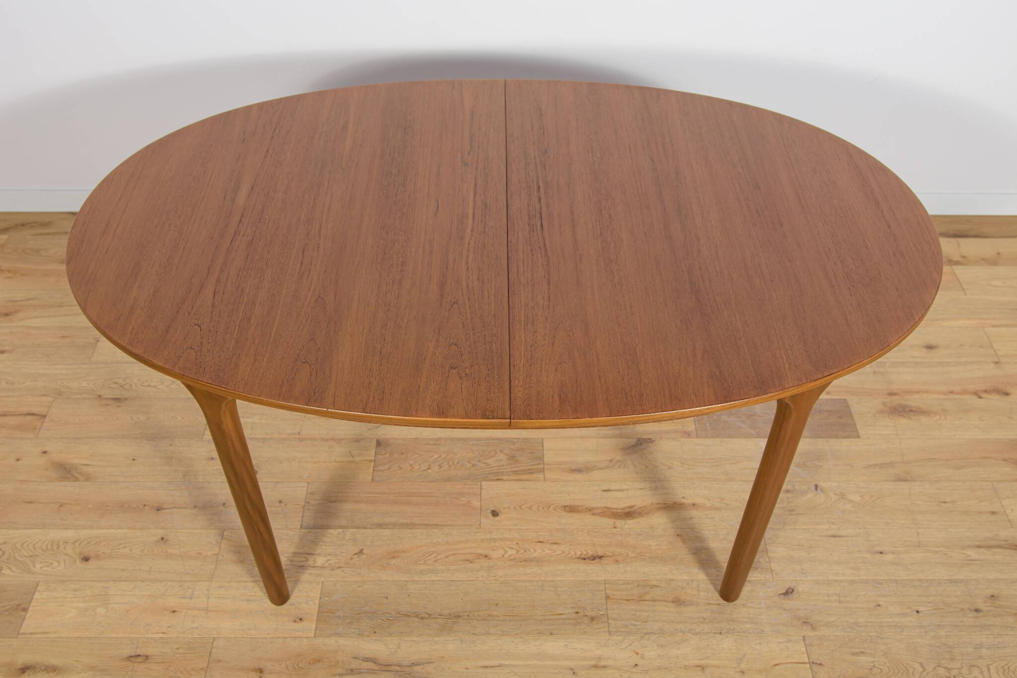 Mid-century extendable oval teak dining table from McIntosh, UK