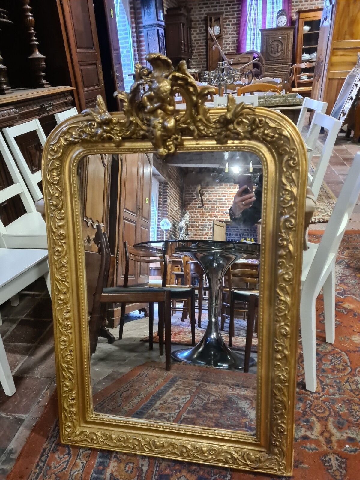 Golden mirror with a flute-playing angel