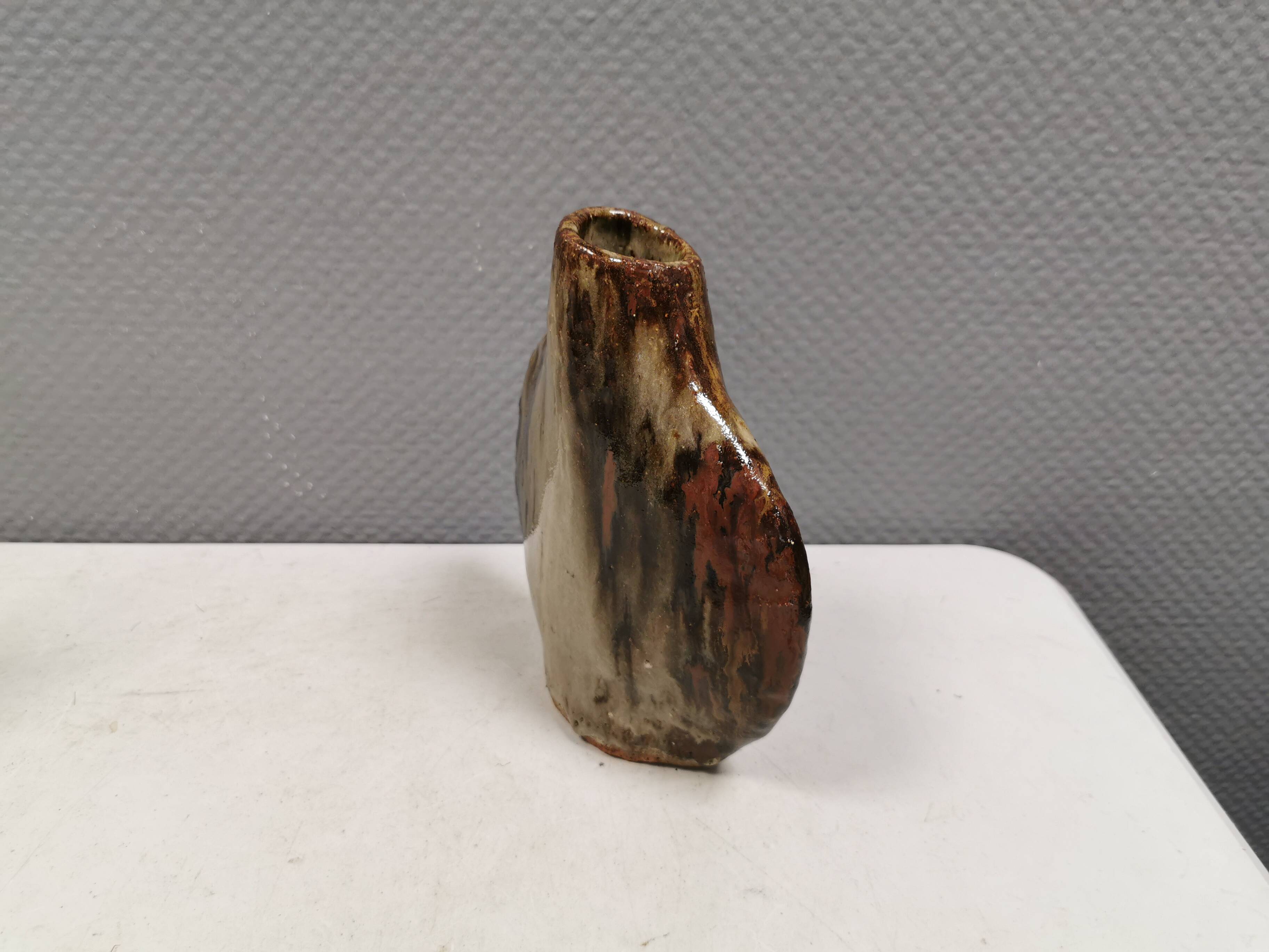 A beautiful Brutalist vase in lovely earth tones. Danish, from the 1980s.