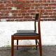 Set of 2 vintage Scandinavian chairs in wood and black faux leather.