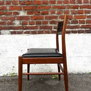 Set of 2 vintage Scandinavian chairs in wood and black faux leather.