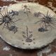 Ceramic plate signed by Marie-Madeleine Jolly – thistle decoration – year