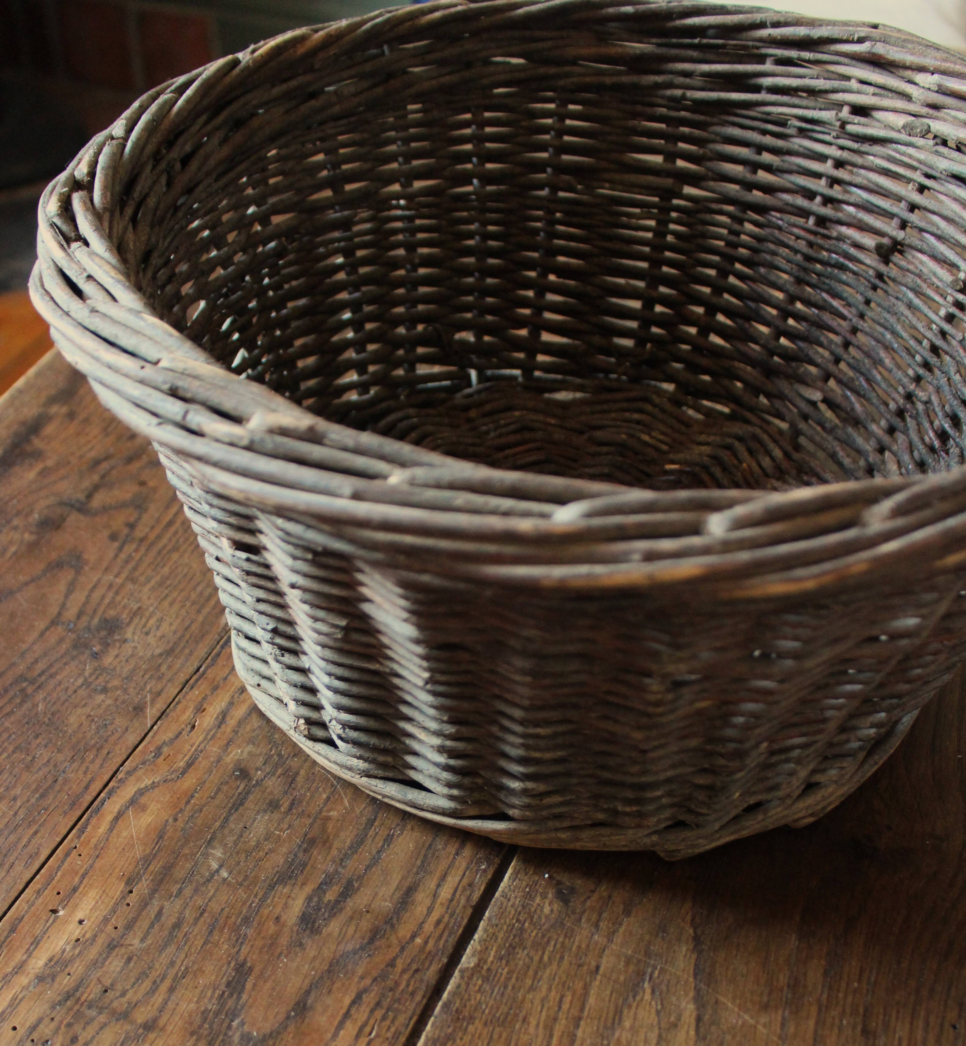 Round wicker basket with a patina