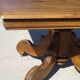 Old walnut table with a central leg.