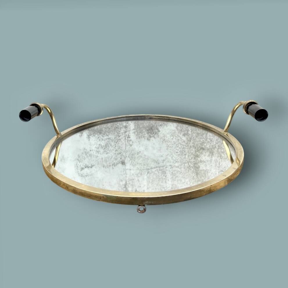 Oval wall mirror in gilded brass with double sconces – 1950s/60s