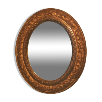 Oval art nouveau mirror in gilded stucco, 50x42 cm