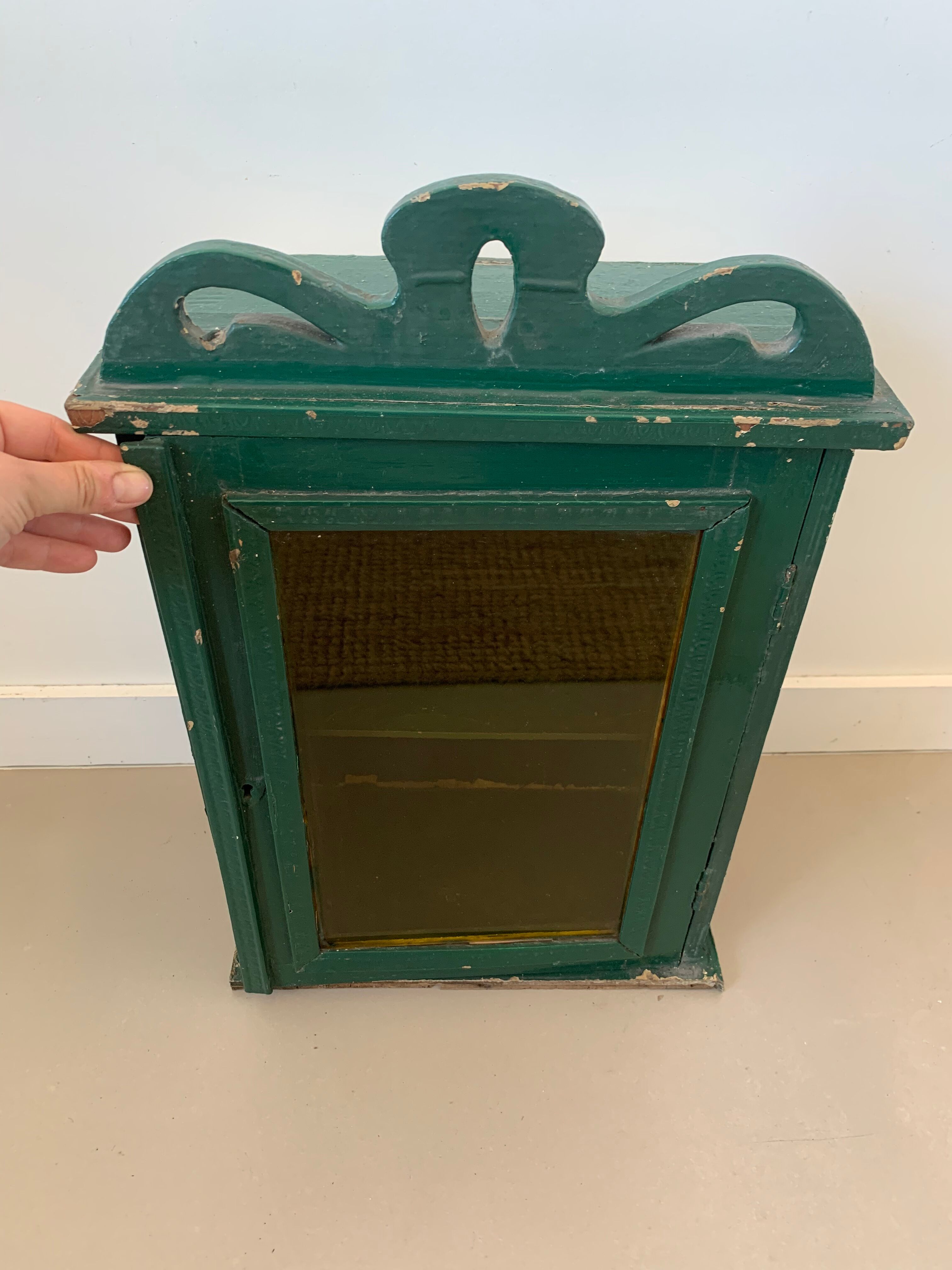 Wall vitrin with pediment