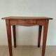 Small antique solid wood table in chic country style with a drawer.
