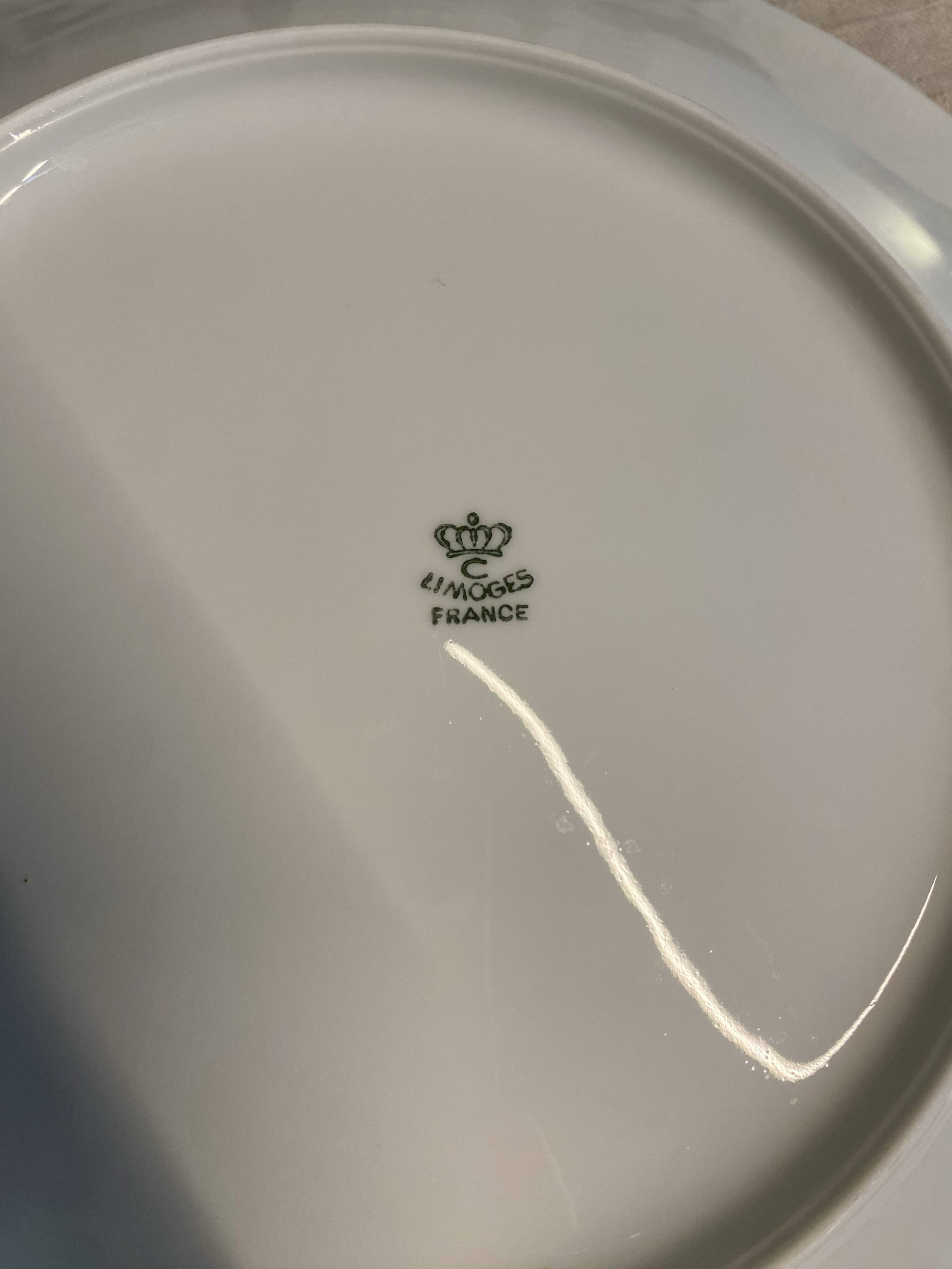 Vintage table service Limoges porcelain white with gold trim.