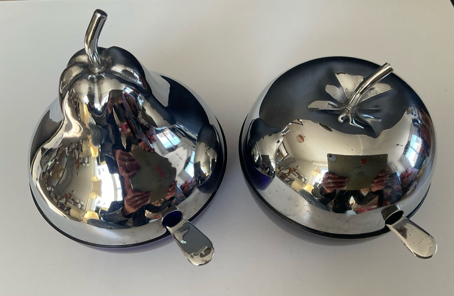 A pair of vintage cobalt glass and silver-plated sugar bowls.