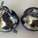 A pair of vintage cobalt glass and silver-plated sugar bowls.