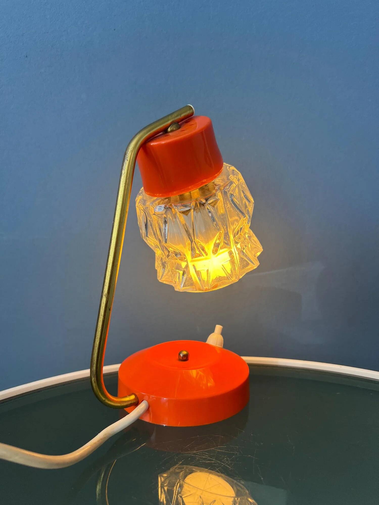 Small orange desk lamp with clear crystal glass shade