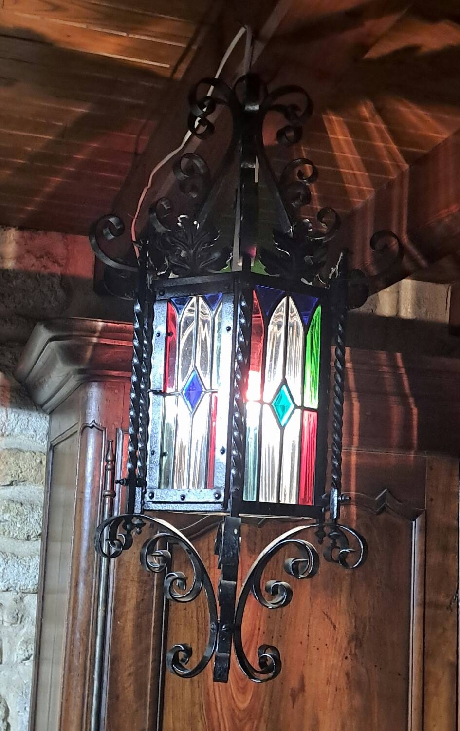 Wrought iron lantern with colored stained glass