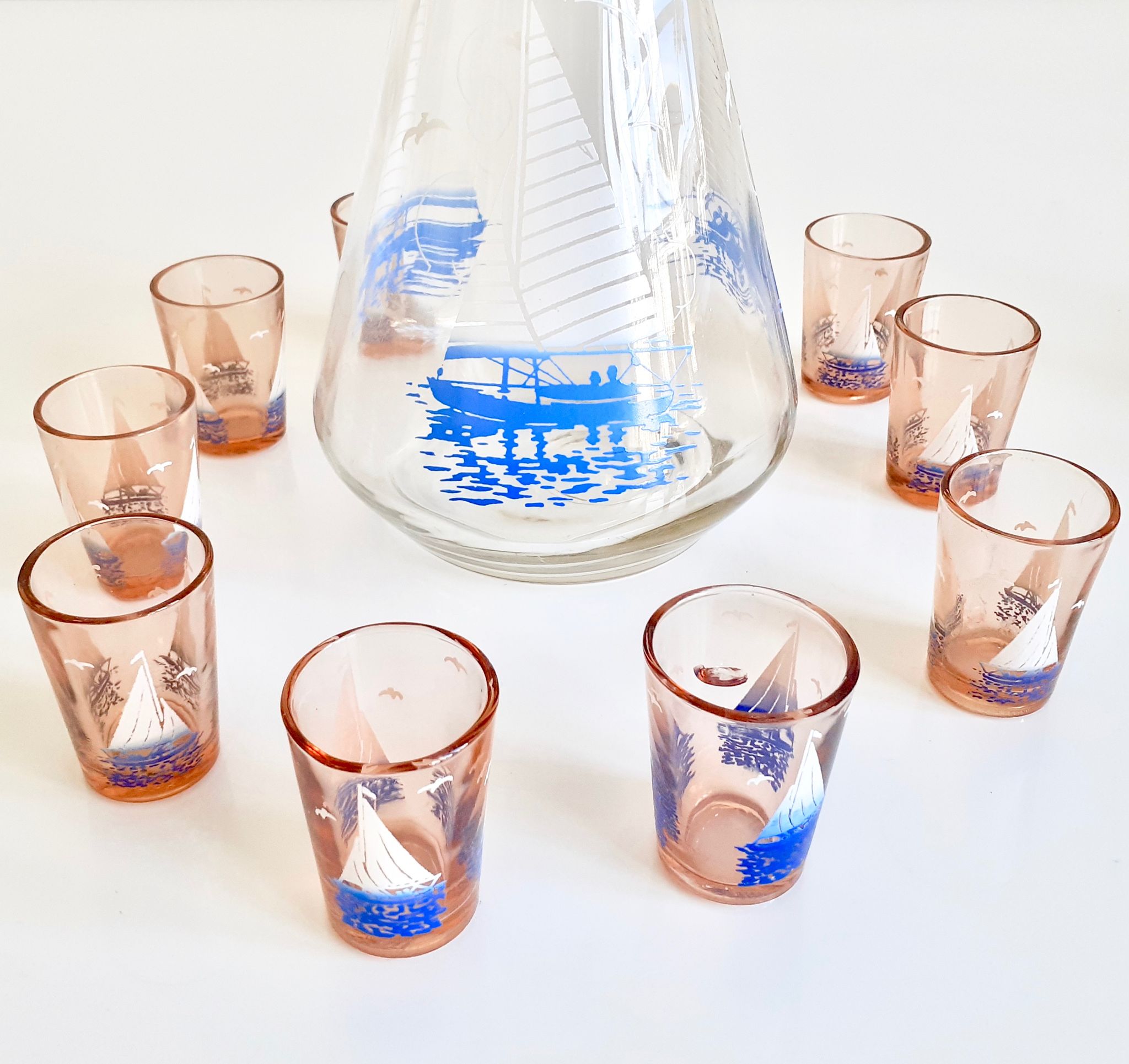 Carafe and 9 liquor glasses decorated with sailboats