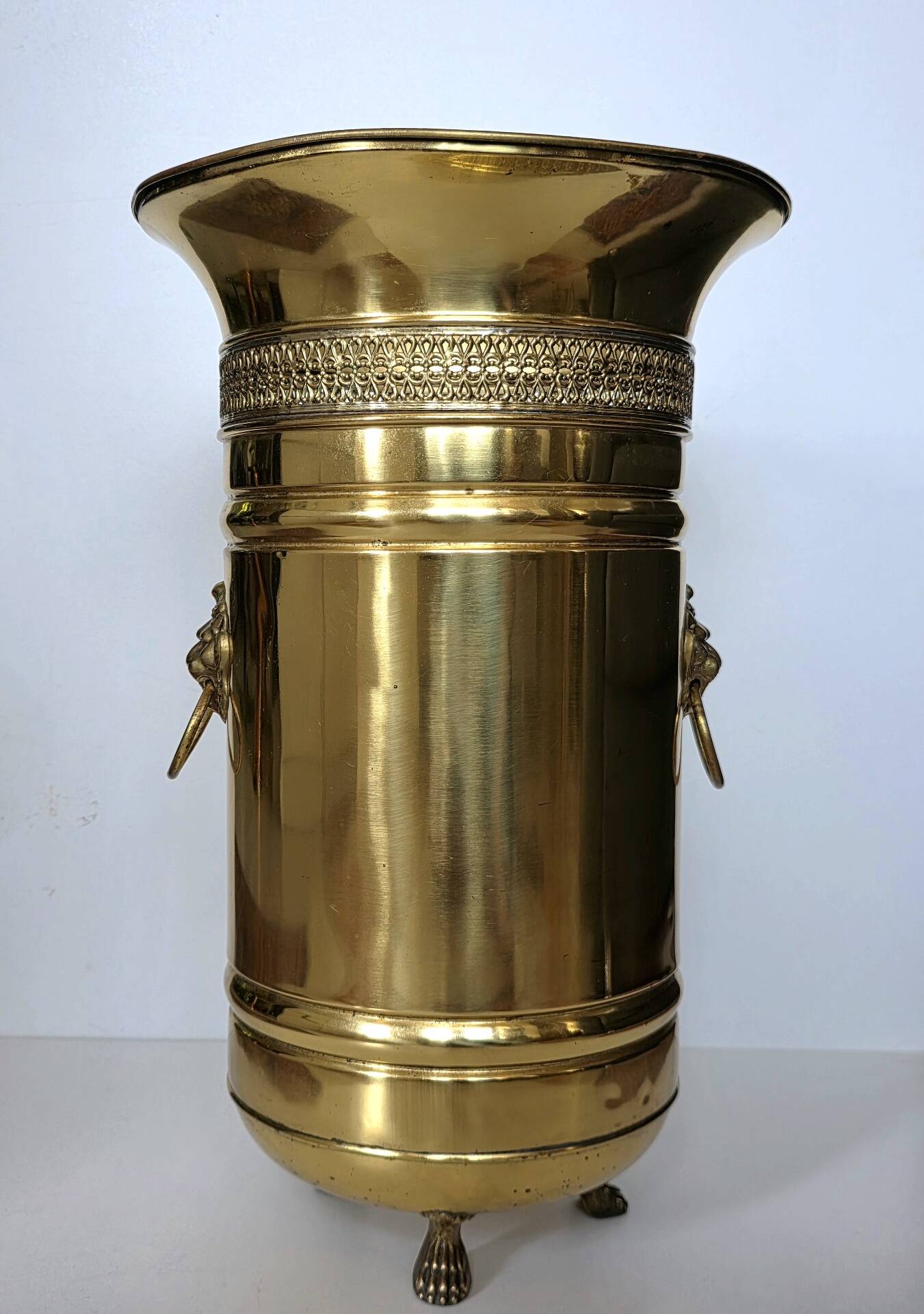 Hollywood Regency style umbrella stand, brass finish and lio pattern.