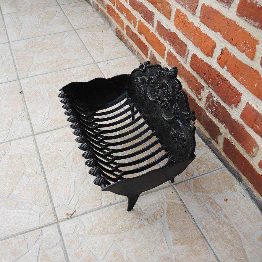 Old cast iron log cradle with backrest