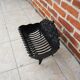 Old cast iron log cradle with backrest