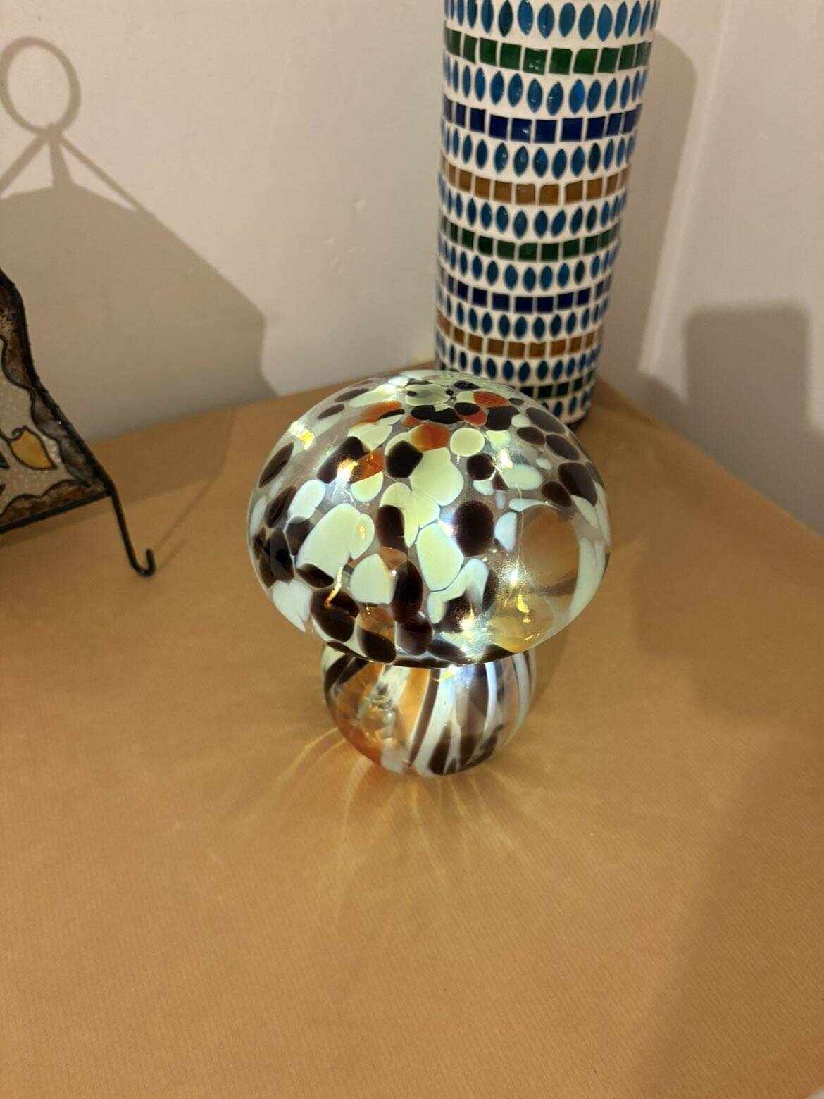 Mosaic glass mushroom lamp in black, white, and amber.