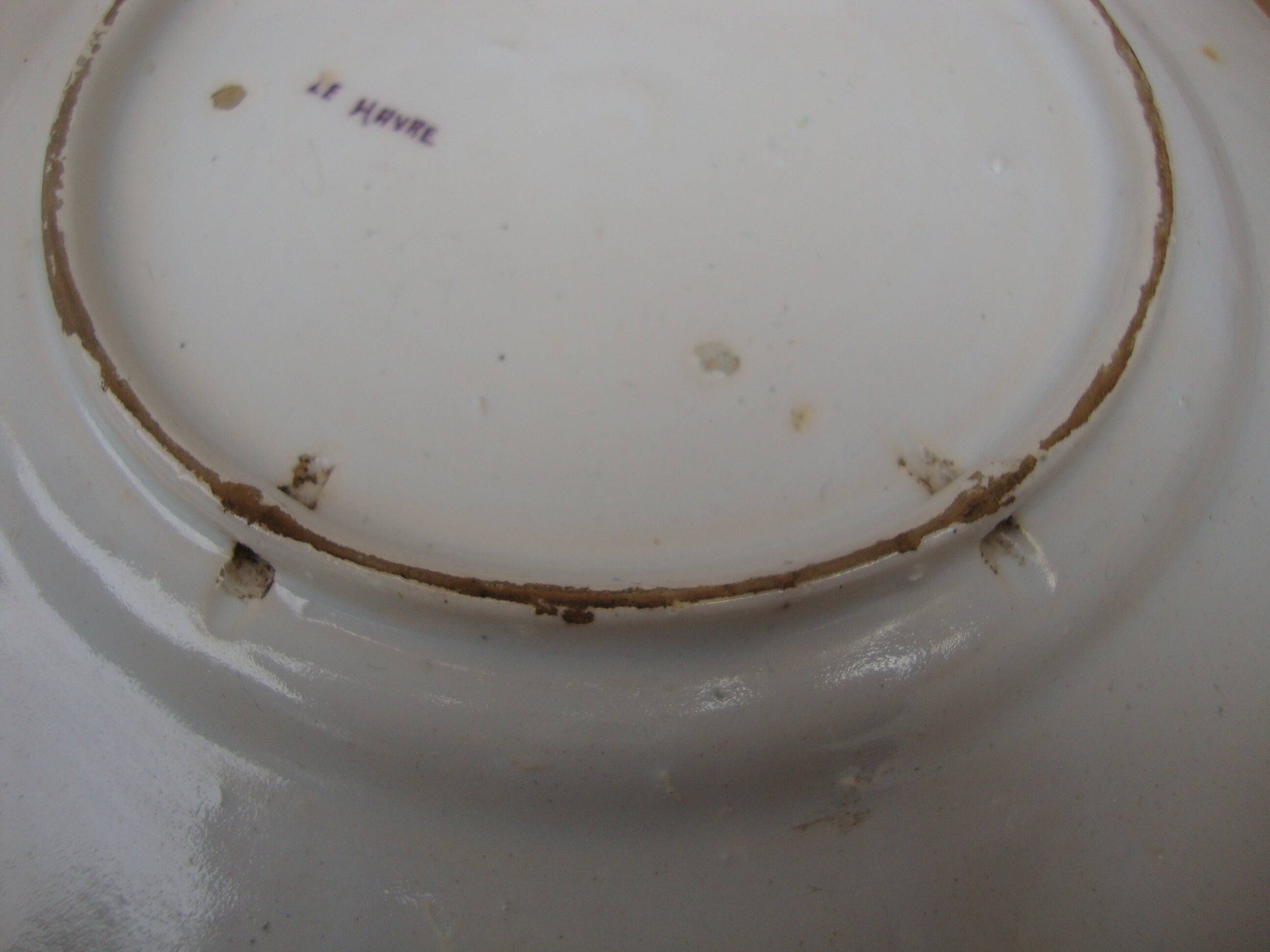 Old earthenware plate decorated with a character marked Le HAVRE