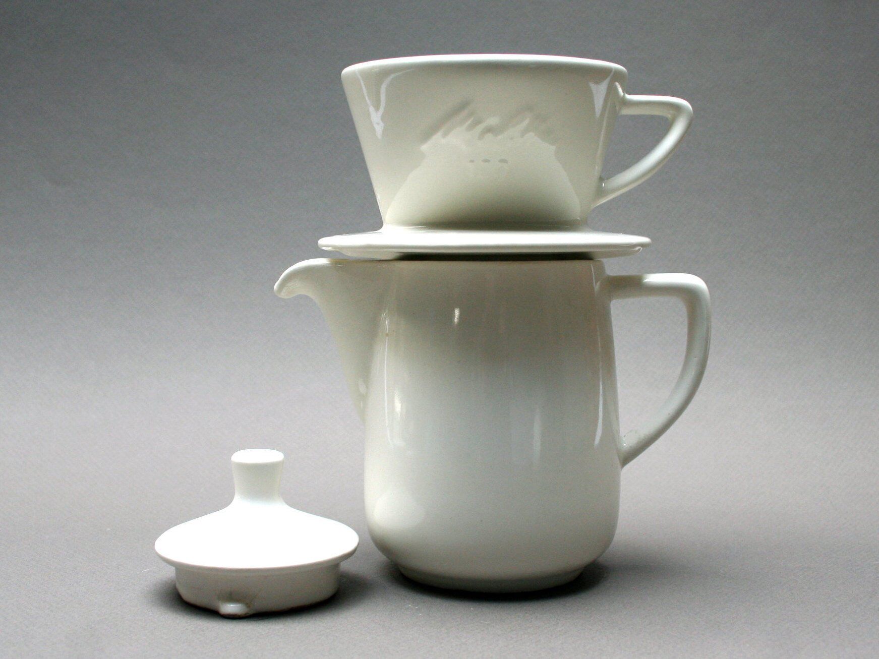 White ceramic coffeemaker and melitta filter, 60 years