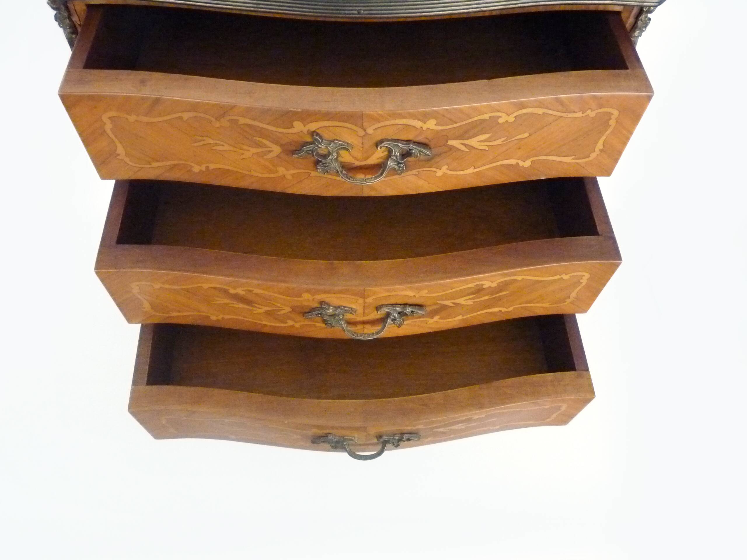 Baroque style wooden chest of drawers with bronze frieze.
