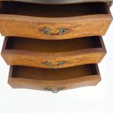 Baroque style wooden chest of drawers with bronze frieze.