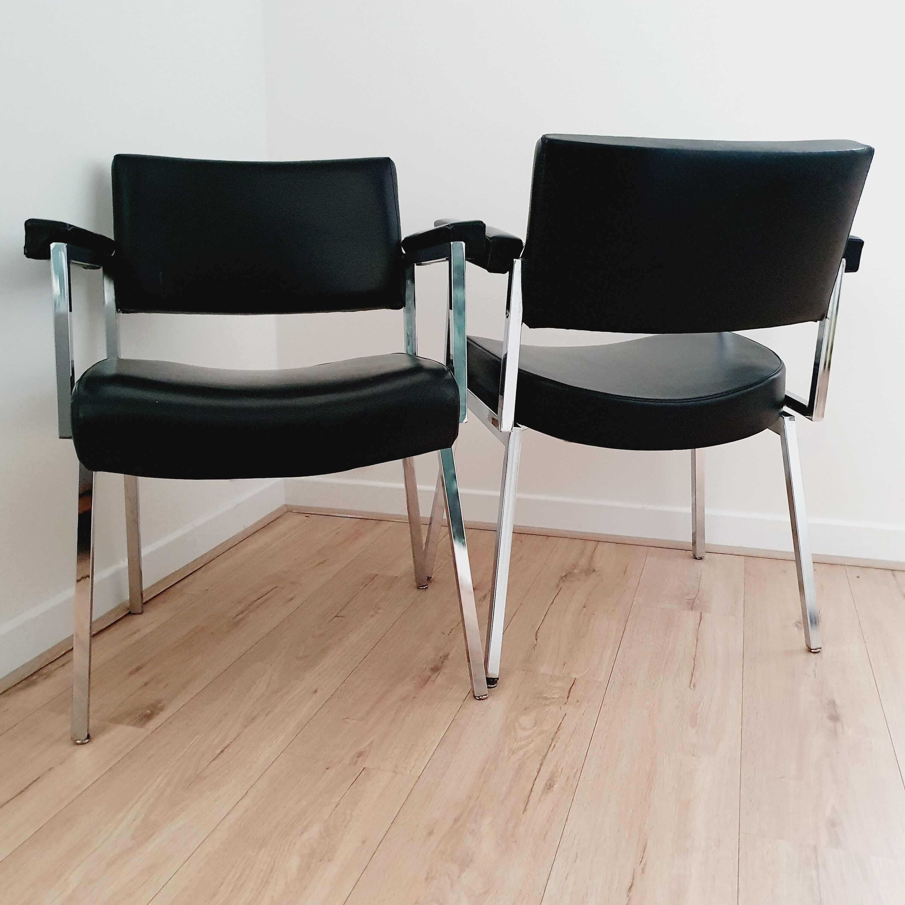 Pair of black skaï and chrome armchairs