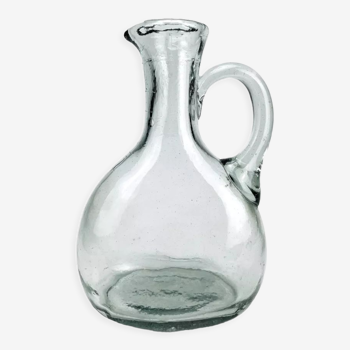 Antique water jug made of thick blown glass