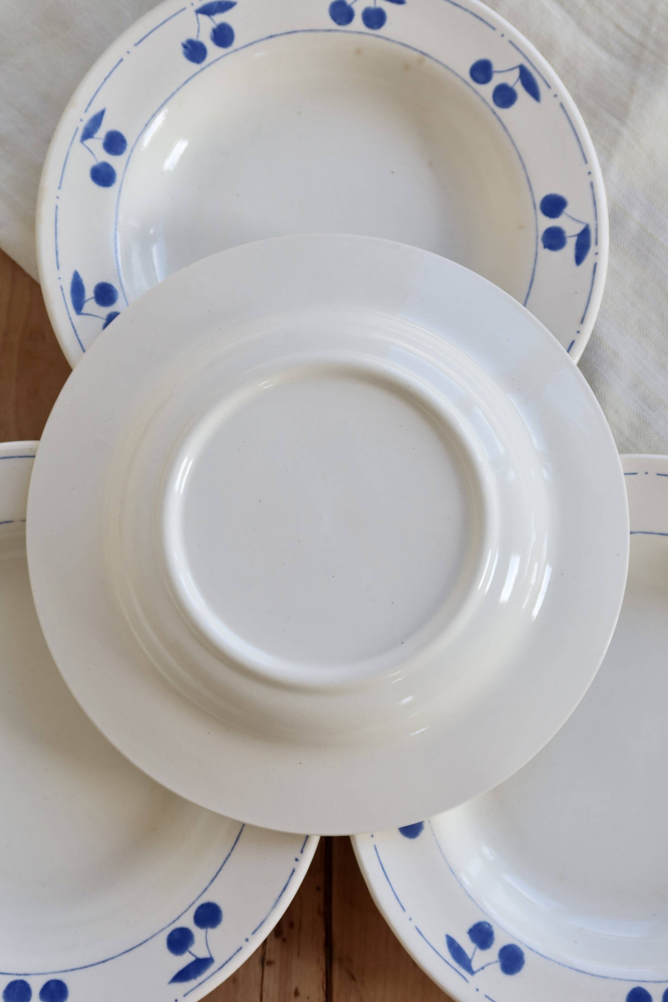 4 vintage deep plates in ivory earthenware with blue cherries