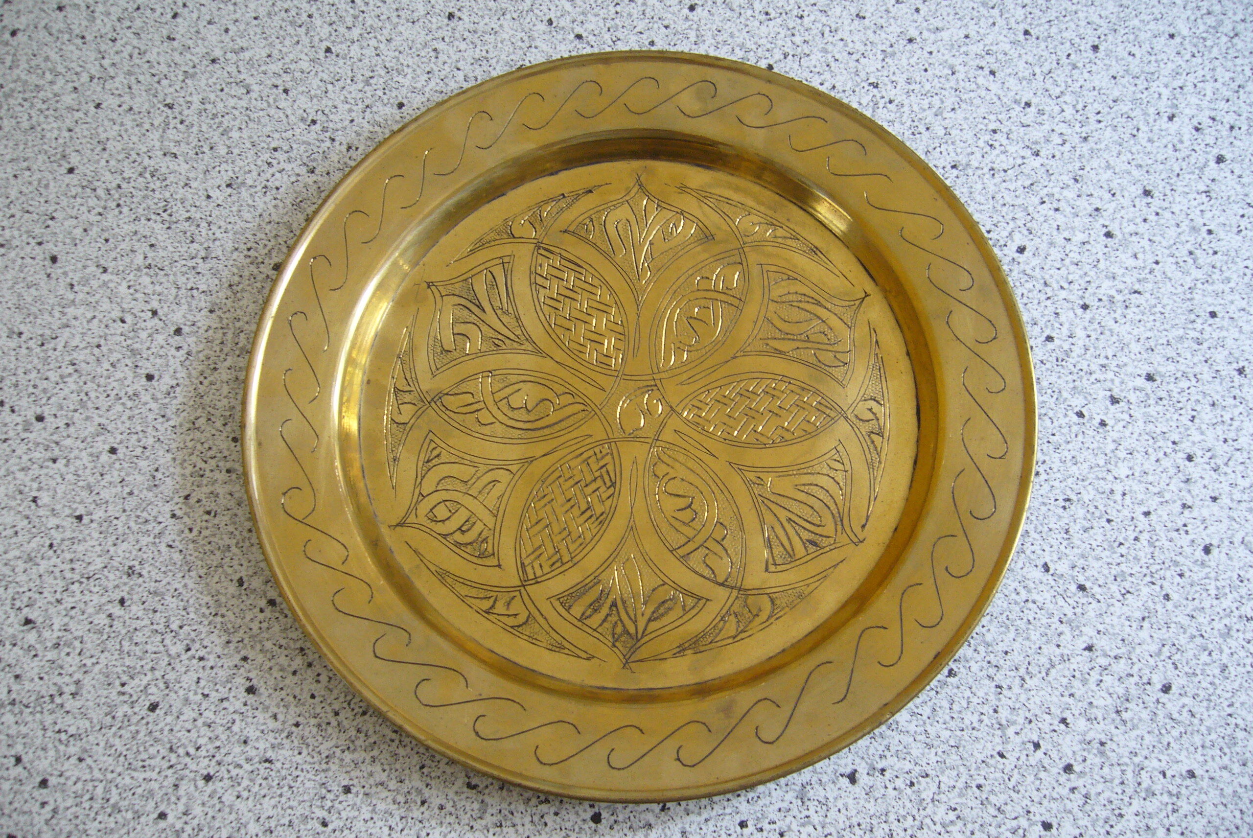Oriental style chiseled metal plate