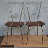 Pair of formica chairs with chrome metal backs in the shape of a lyre.