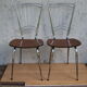 Pair of formica chairs with chrome metal backs in the shape of a lyre.