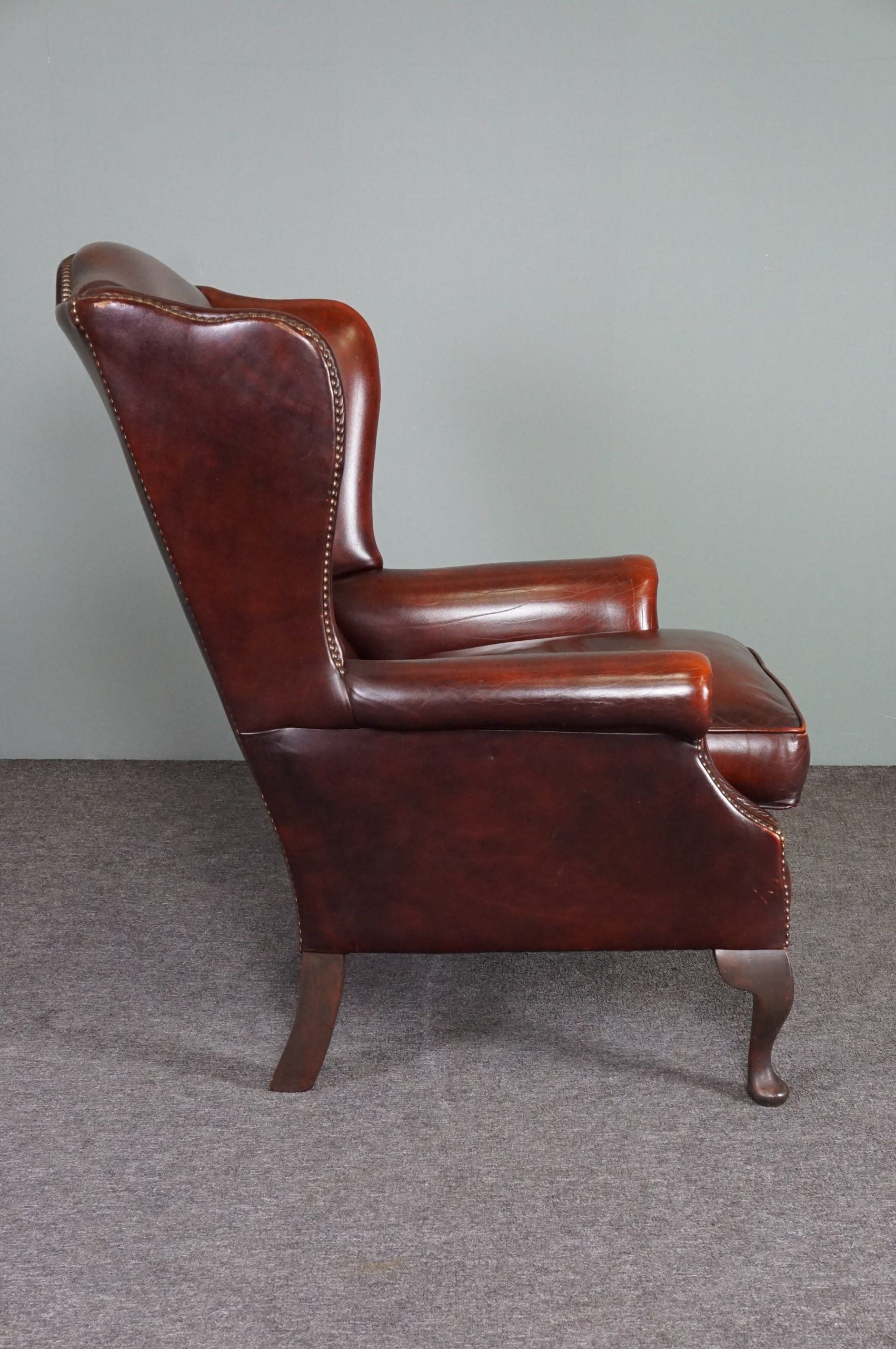 Leather armchair with decorative nails