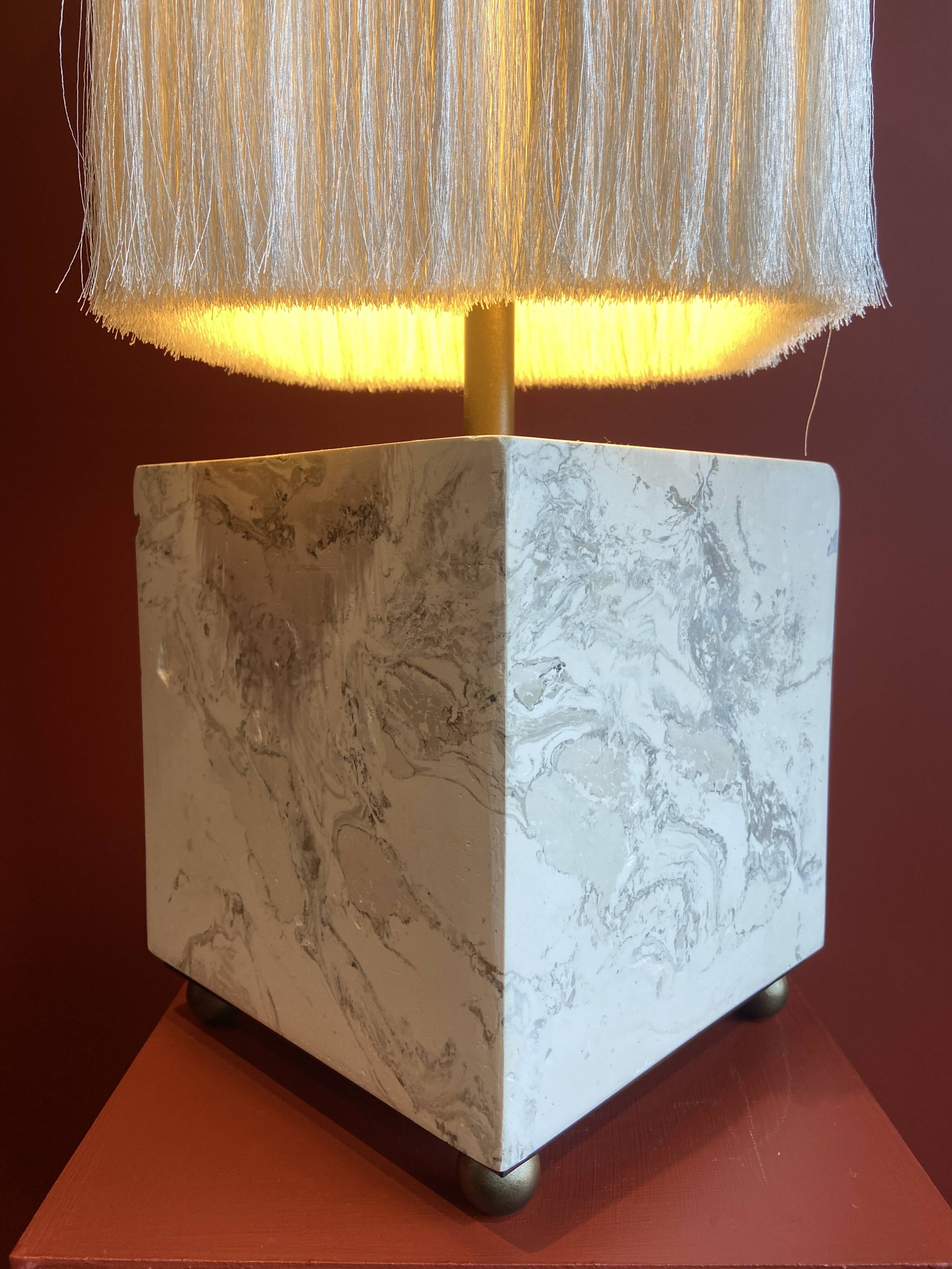 Beige marble stucco base, Houles white ecru fringed lampshade.