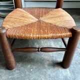 Brutalist low chair in dark wood and straw no. 2