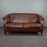2-seater sofa in sheepskin decorative nails
