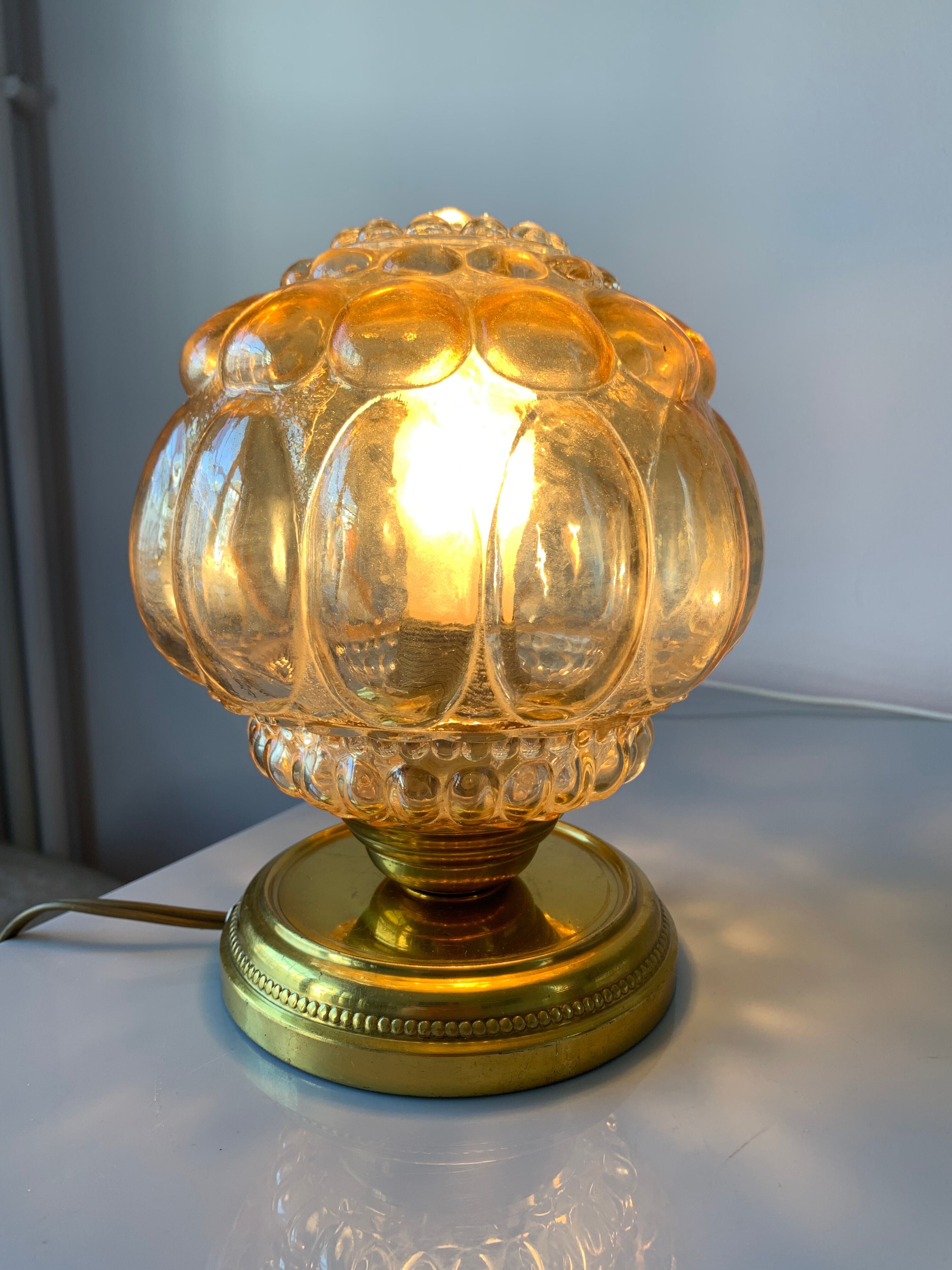 Old vintage table lamp made of amber molded glass