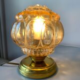 Old vintage table lamp made of amber molded glass