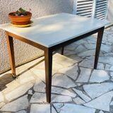 Vintage oak farmhouse table with a white top.