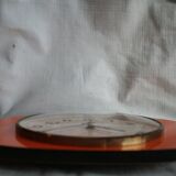Vintage wall clock in orange formica