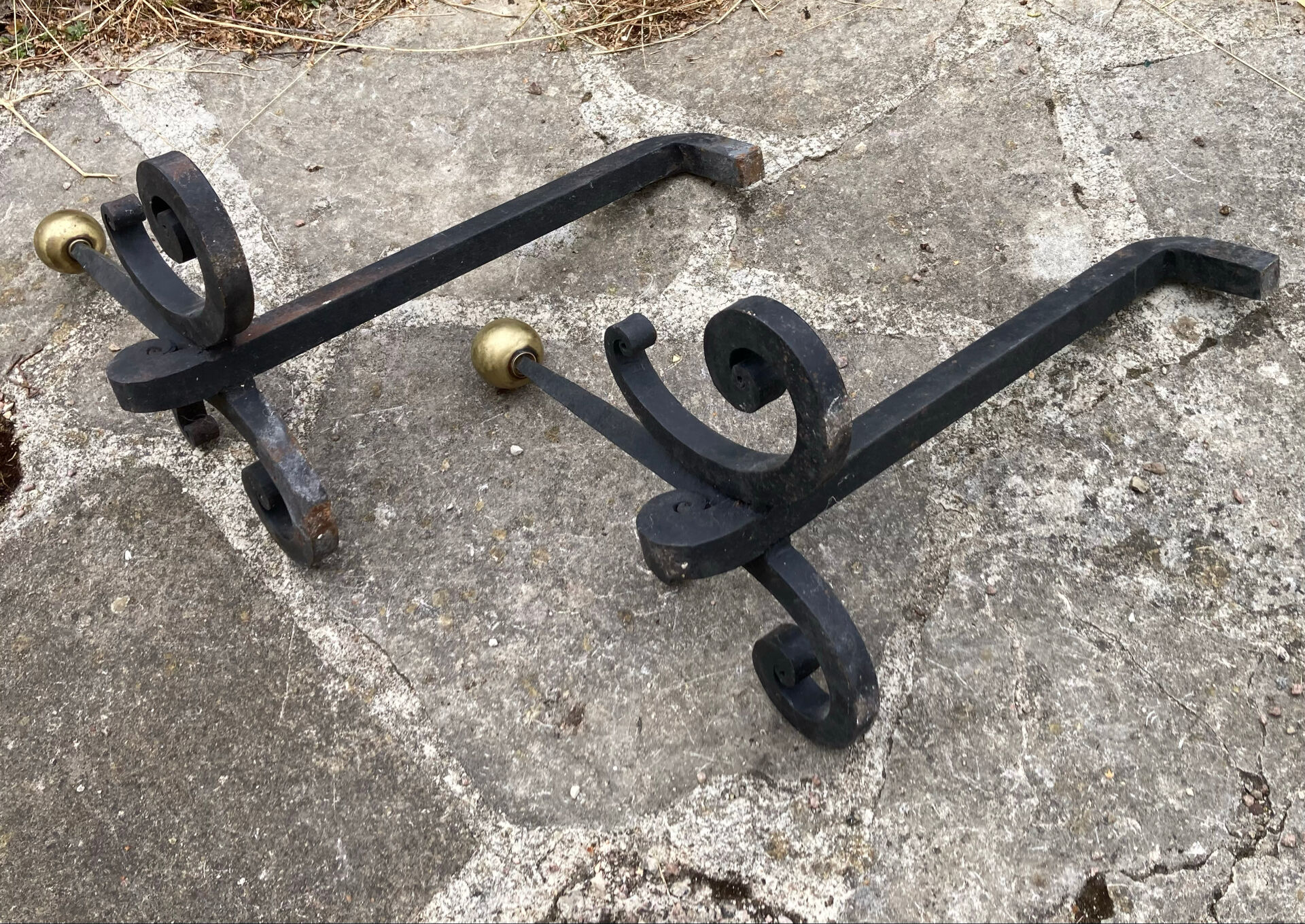 Massive wrought iron chenets from the 19th century topped with brass balls.