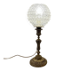 Antique brass foot lamp with glass globe and diamond point.