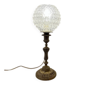 Antique brass foot lamp with glass globe and diamond point.