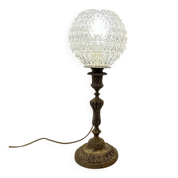 Antique brass foot lamp with glass globe and diamond point.