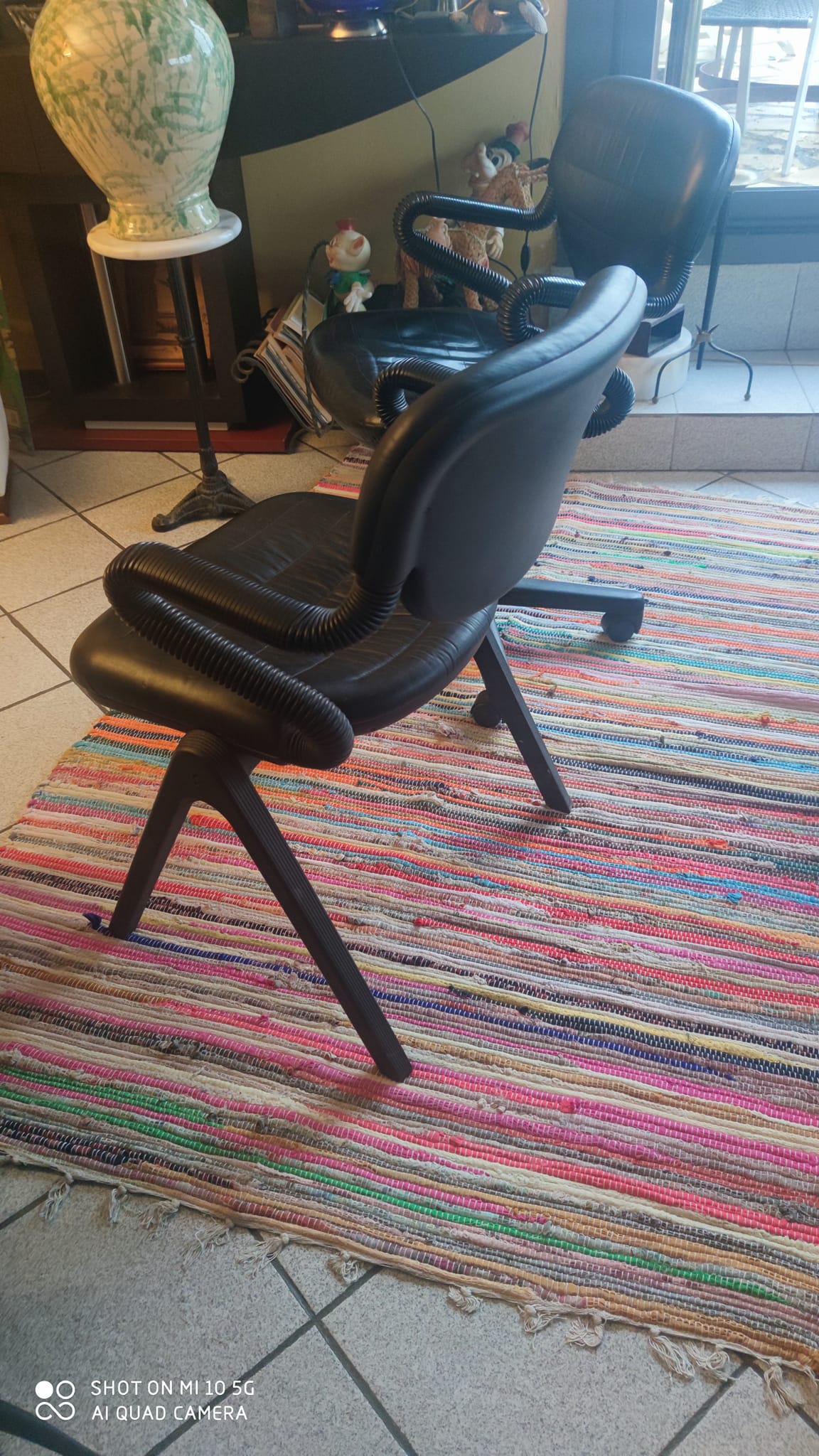 Two black leather armchairs