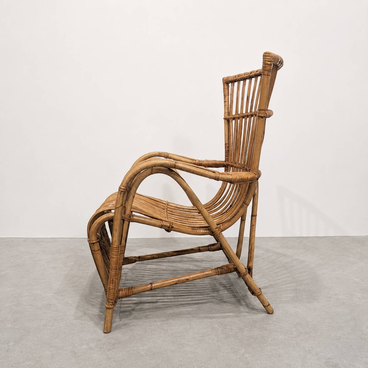 Vintage armchair from the 70s in natural rattan.